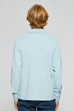 Polo de manga larga de tres botones en azul claro con logo Rigby Go